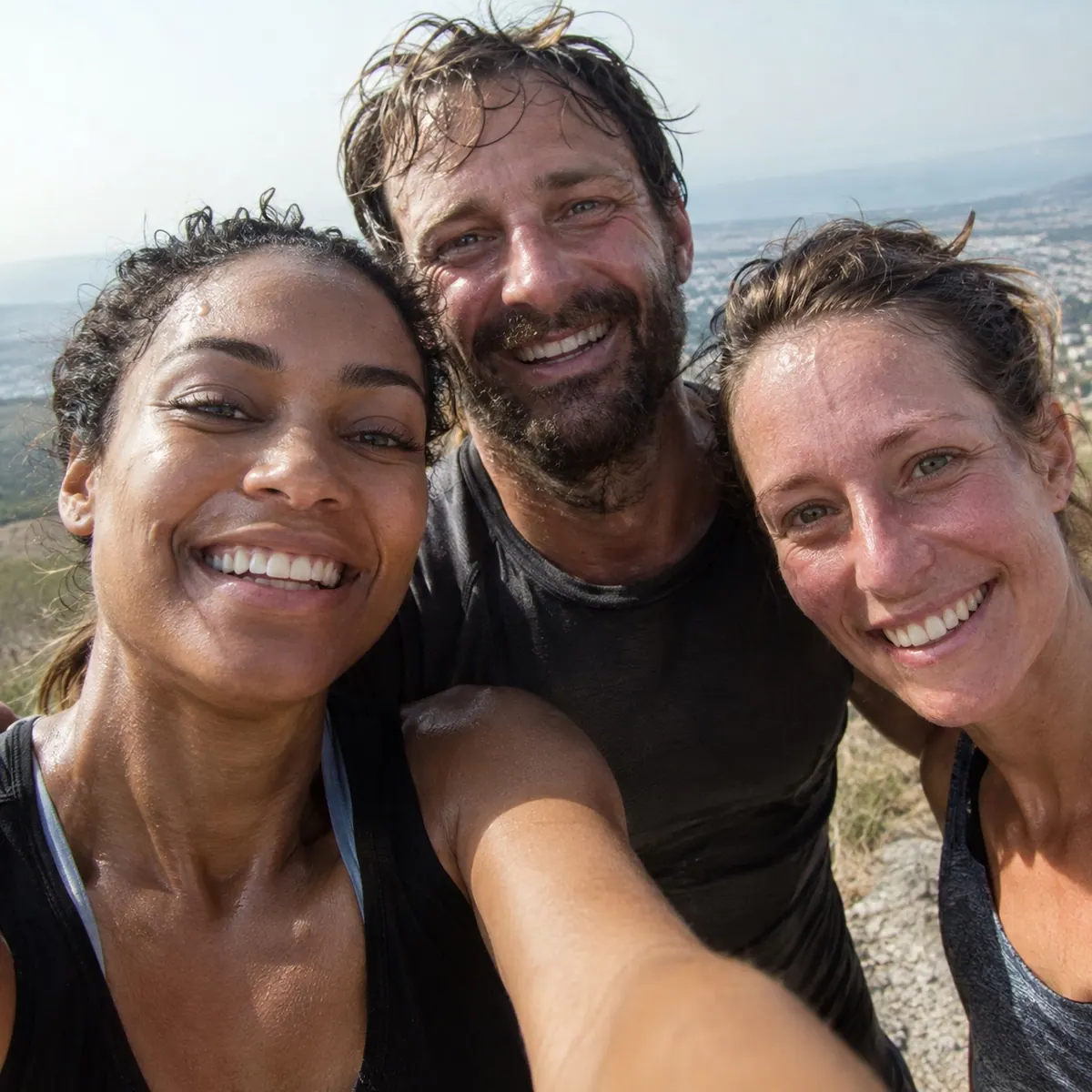 A selfie of friends after a workout, sweaty and smiling.